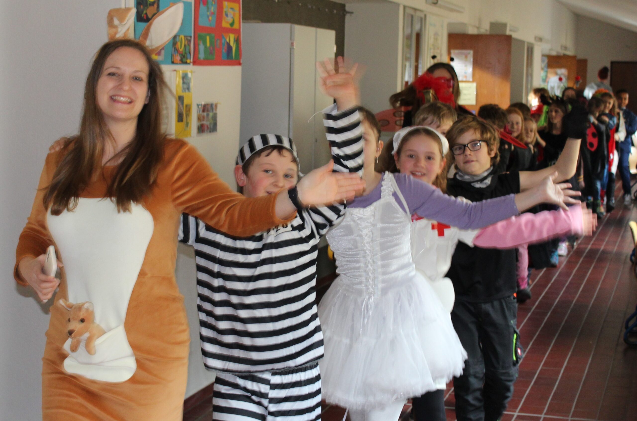 Eine Lehrerin als Känguru verkleidet führt die Polonaise aller Schulkinder an.