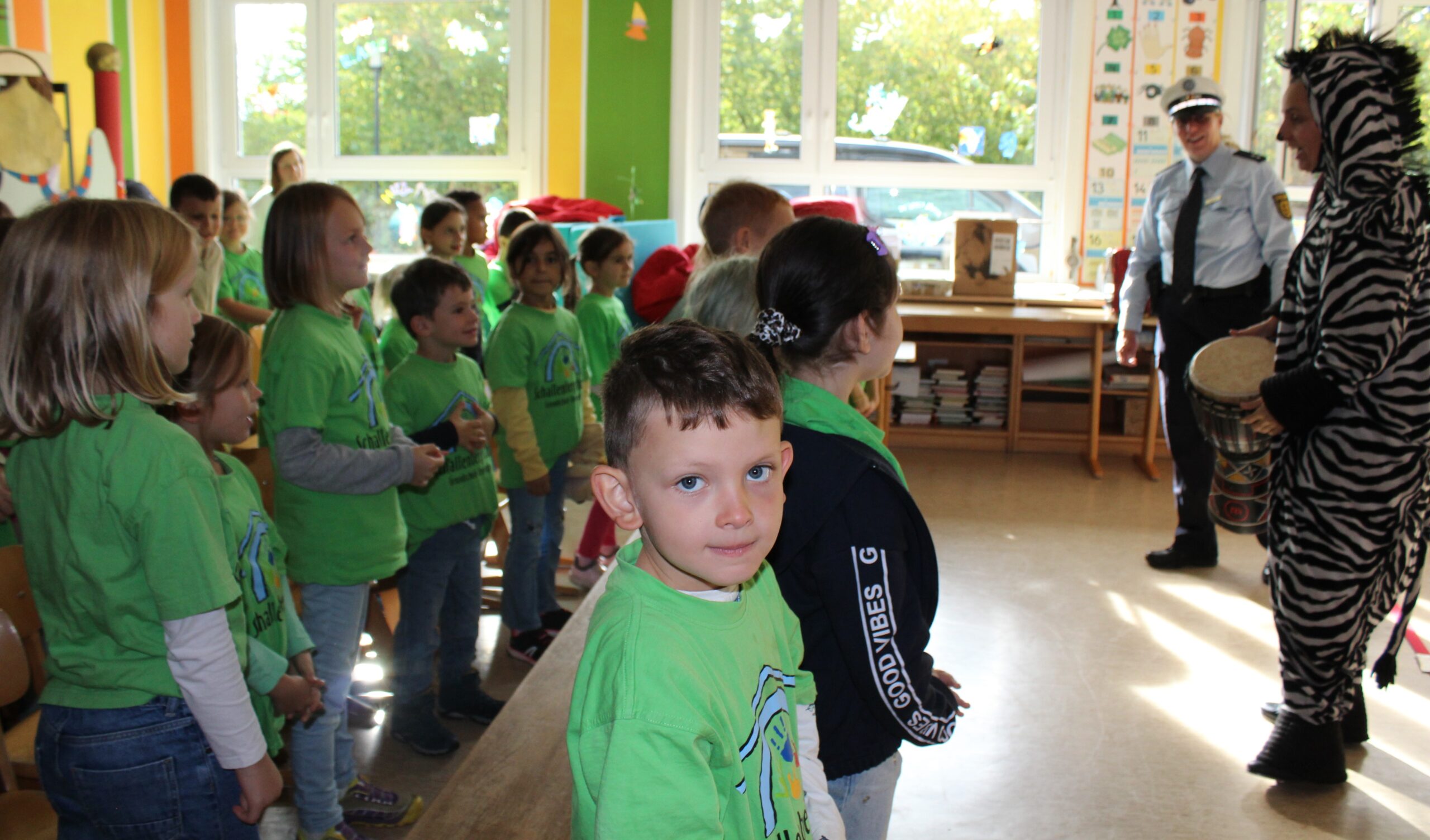 Die Polizistin und die Schauspielerin singen mit den Schulkindern.