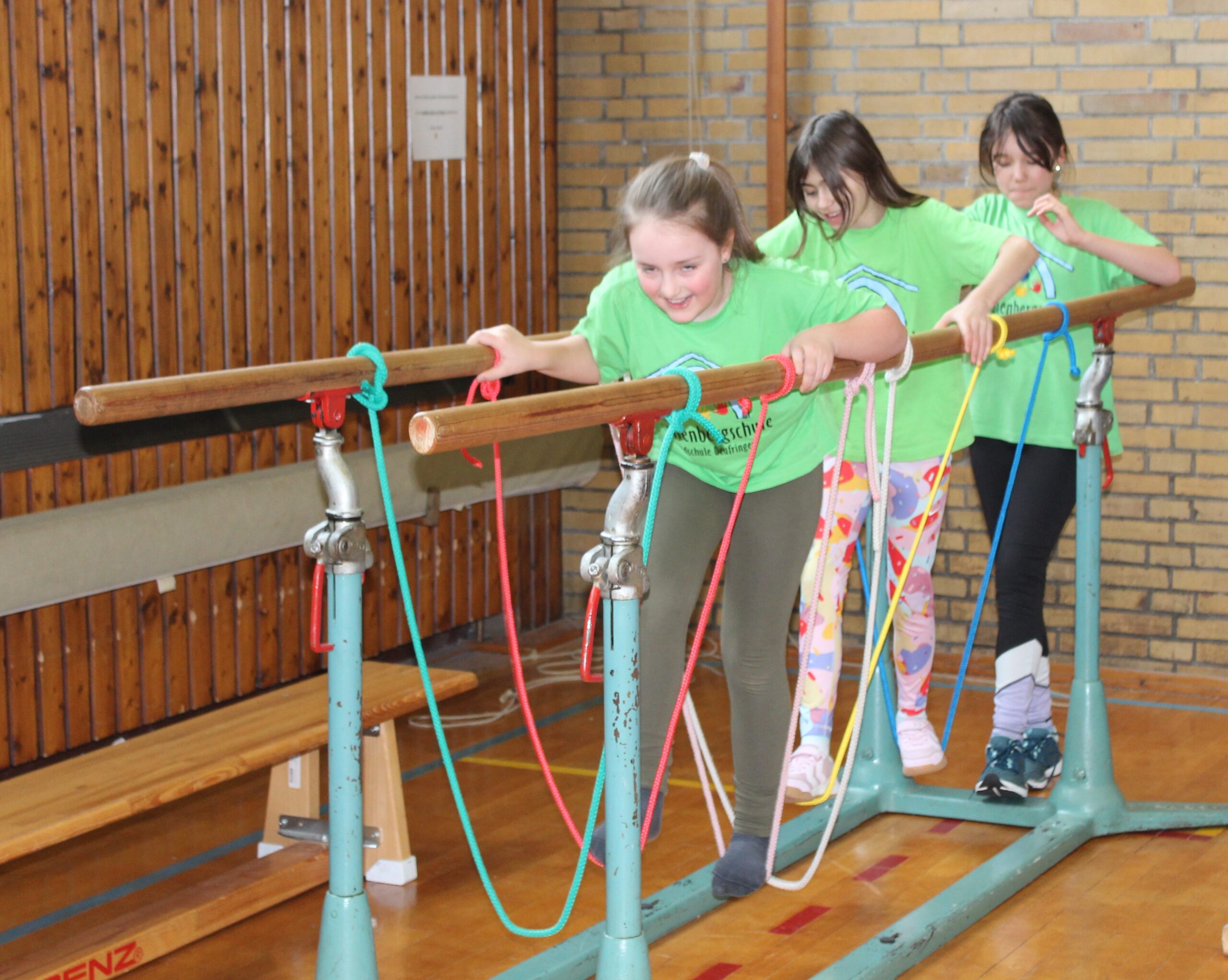 Kinder laufen über Seile als Hängebrücke in einen Barren geknüpft.